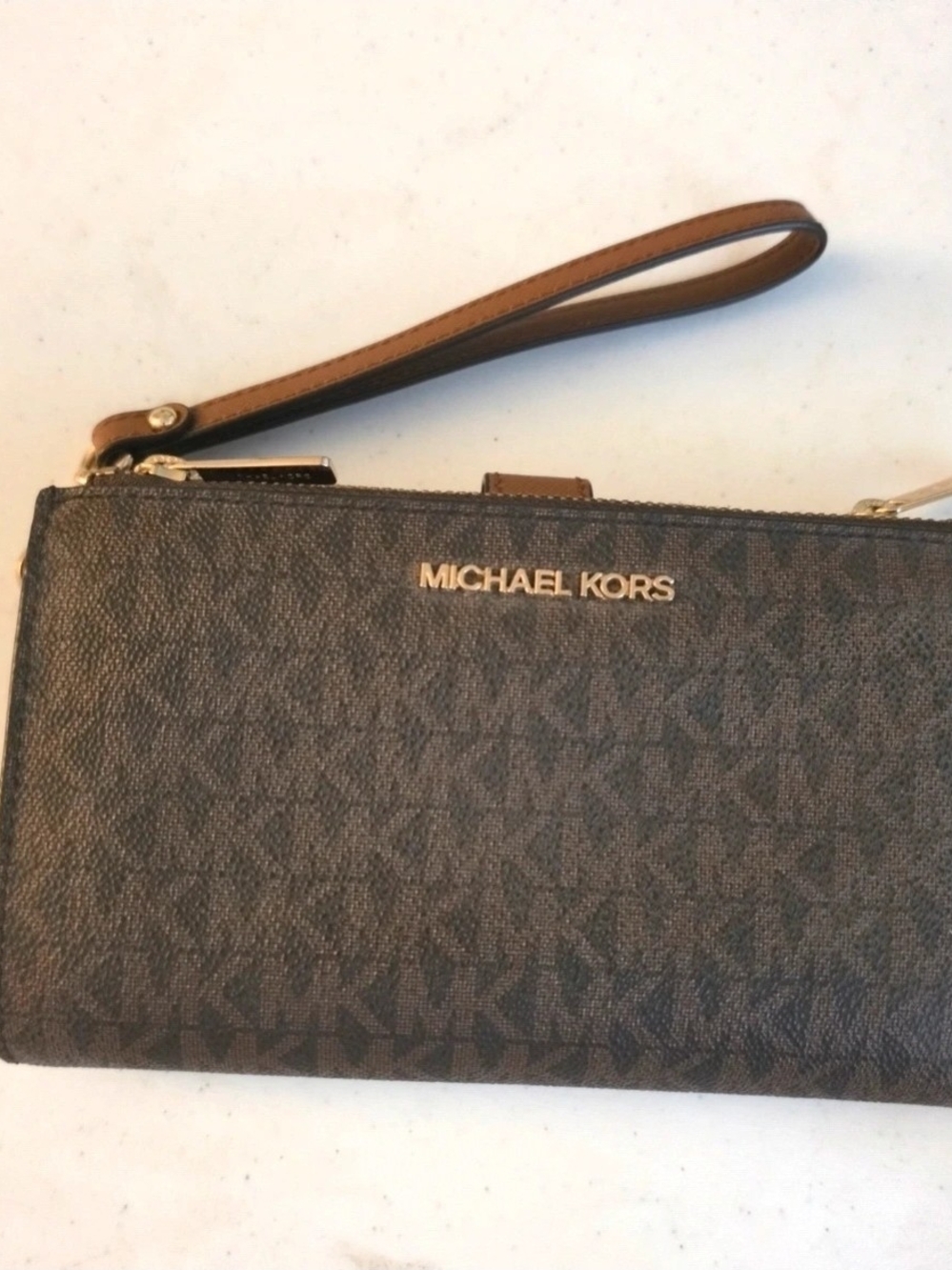 Michael Kors women's wristlet wallet in brown.